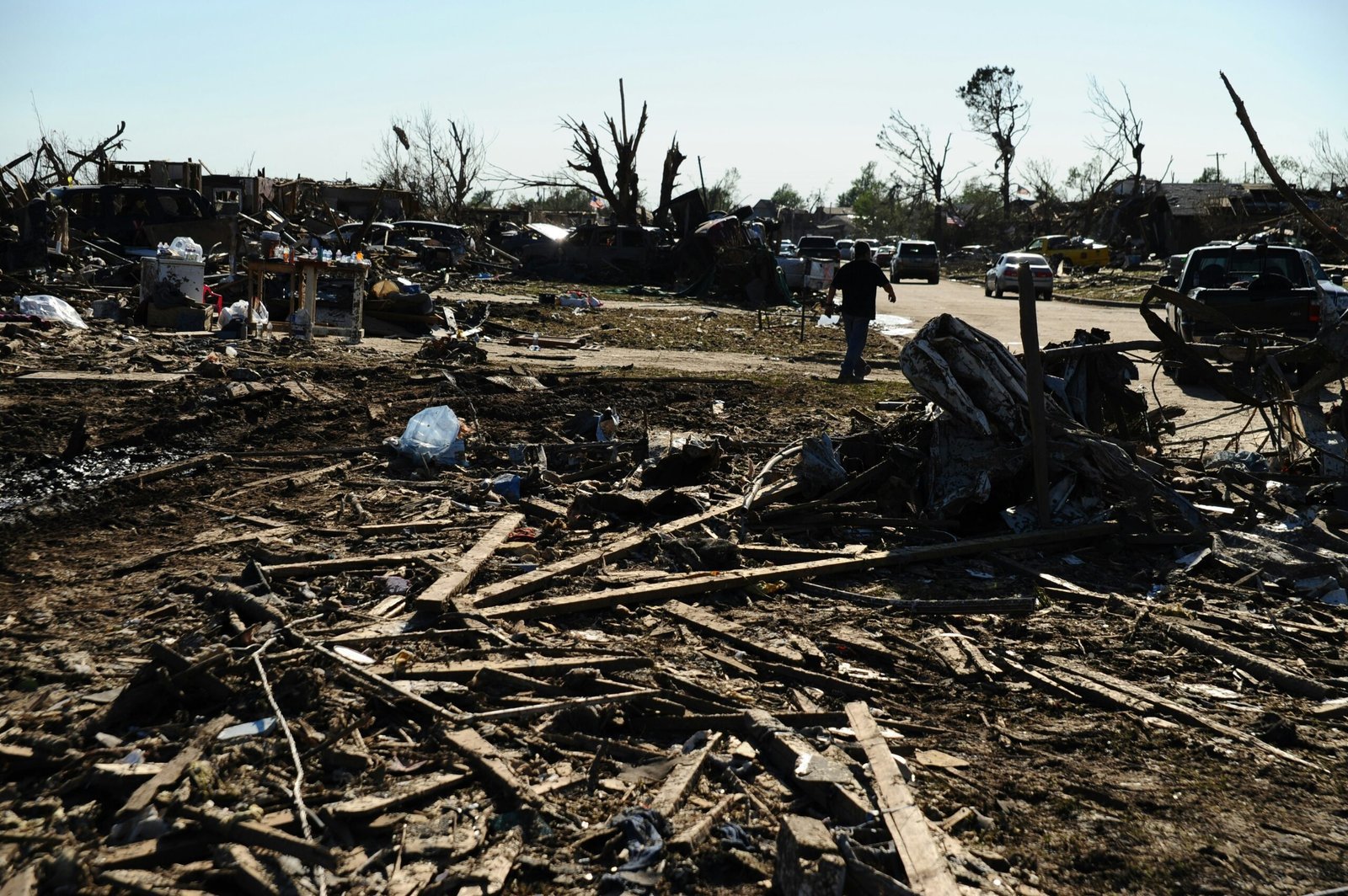 climmaate disasters destruction: a pile of debris sitting on top of a dirt field